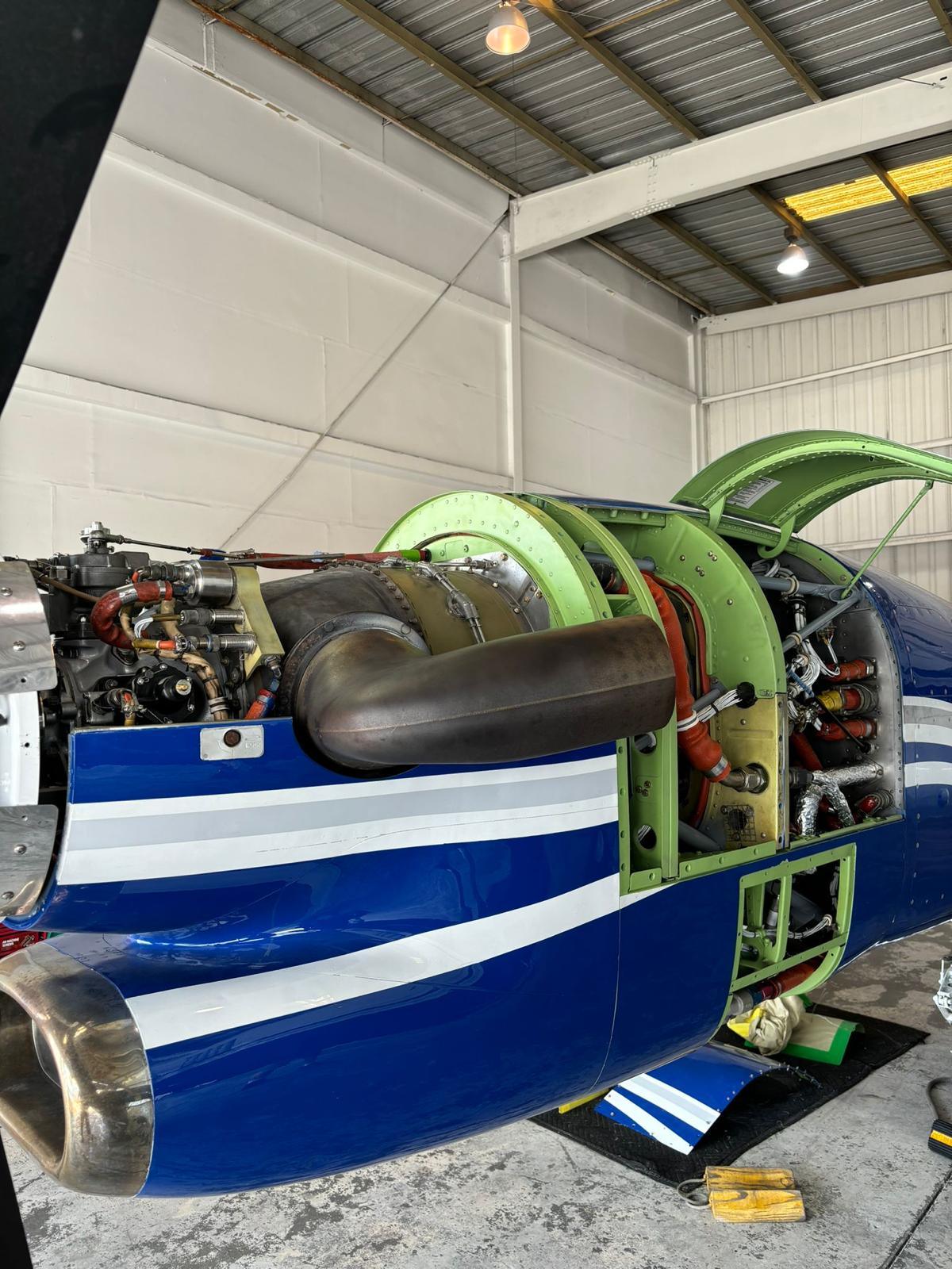 Pratt and Whitney PT6 turbine fully exposed on a blue King Air with the cowl frames opened.
