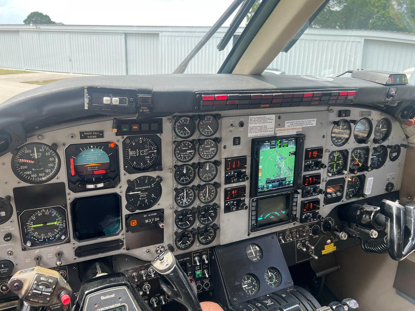 King Air cockpit with dual Garmin displays fitted alongside original round-dial instruments.