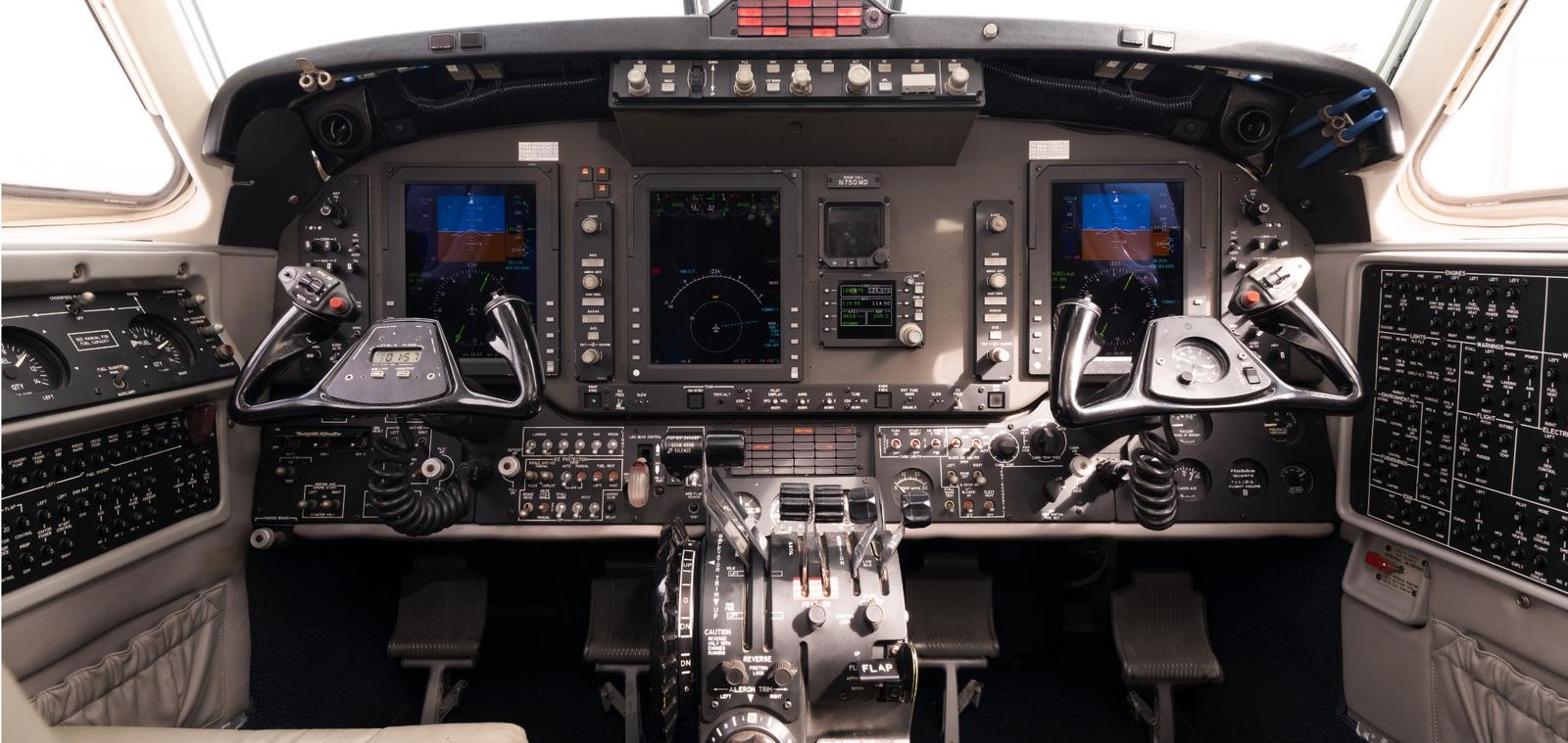 Cessna Citation cockpit showing the full instrument panel and centre pedestal.