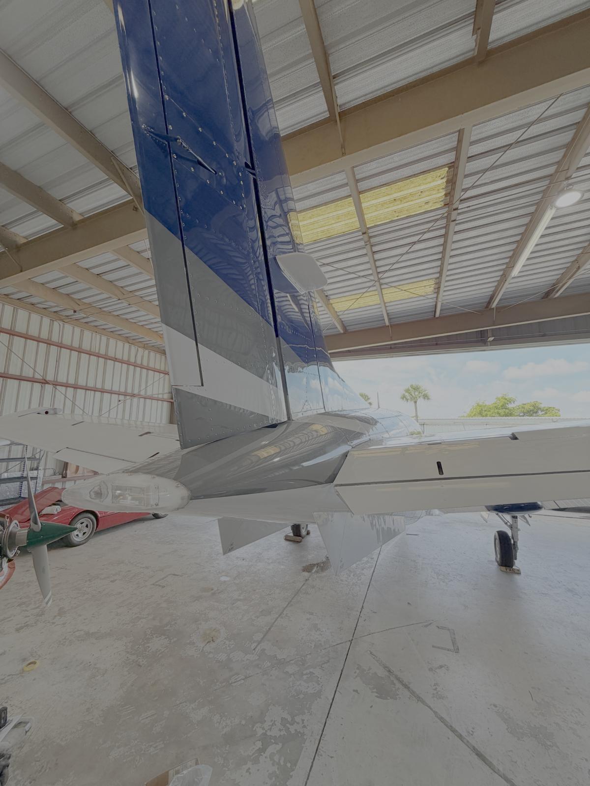 Close view of a freshly painted blue King Air nacelle with crisp white stripe work and Beechcraft lettering.