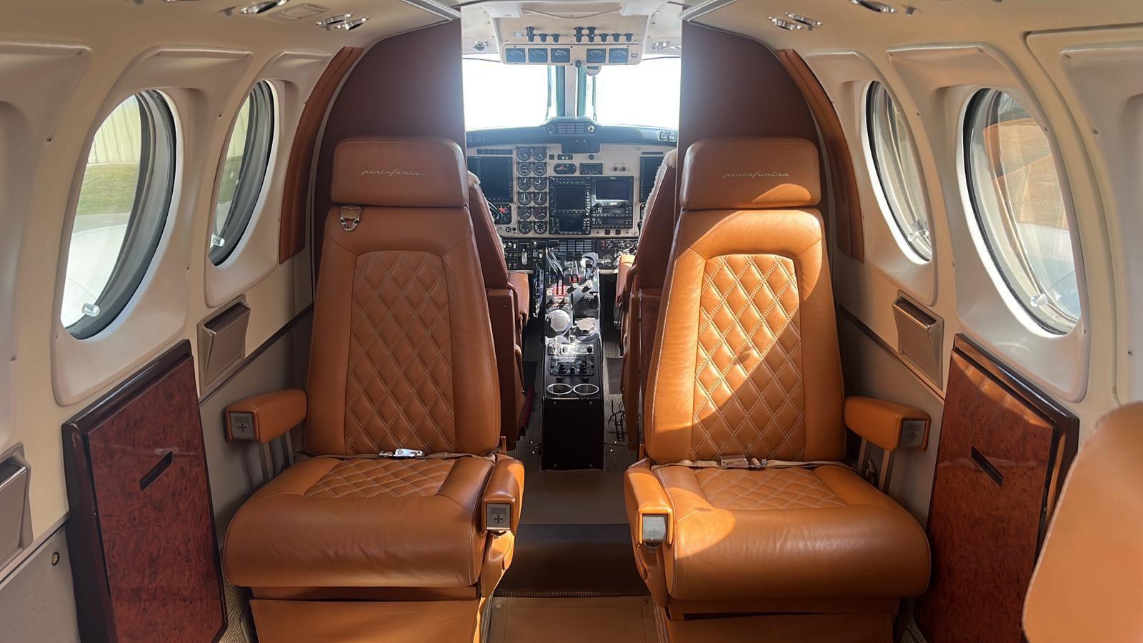 Finished King Air cabin with tan and grey quilted leather seats, ebony veneer and new sidewalls.