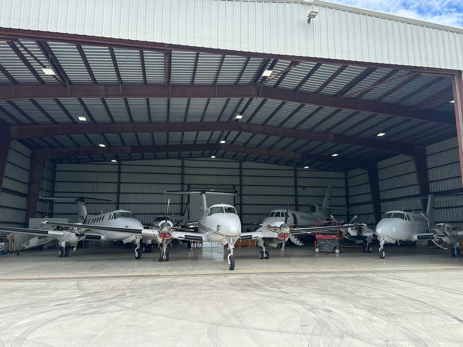 Multiple aircraft positioned across the 305 Sky hangar floor.