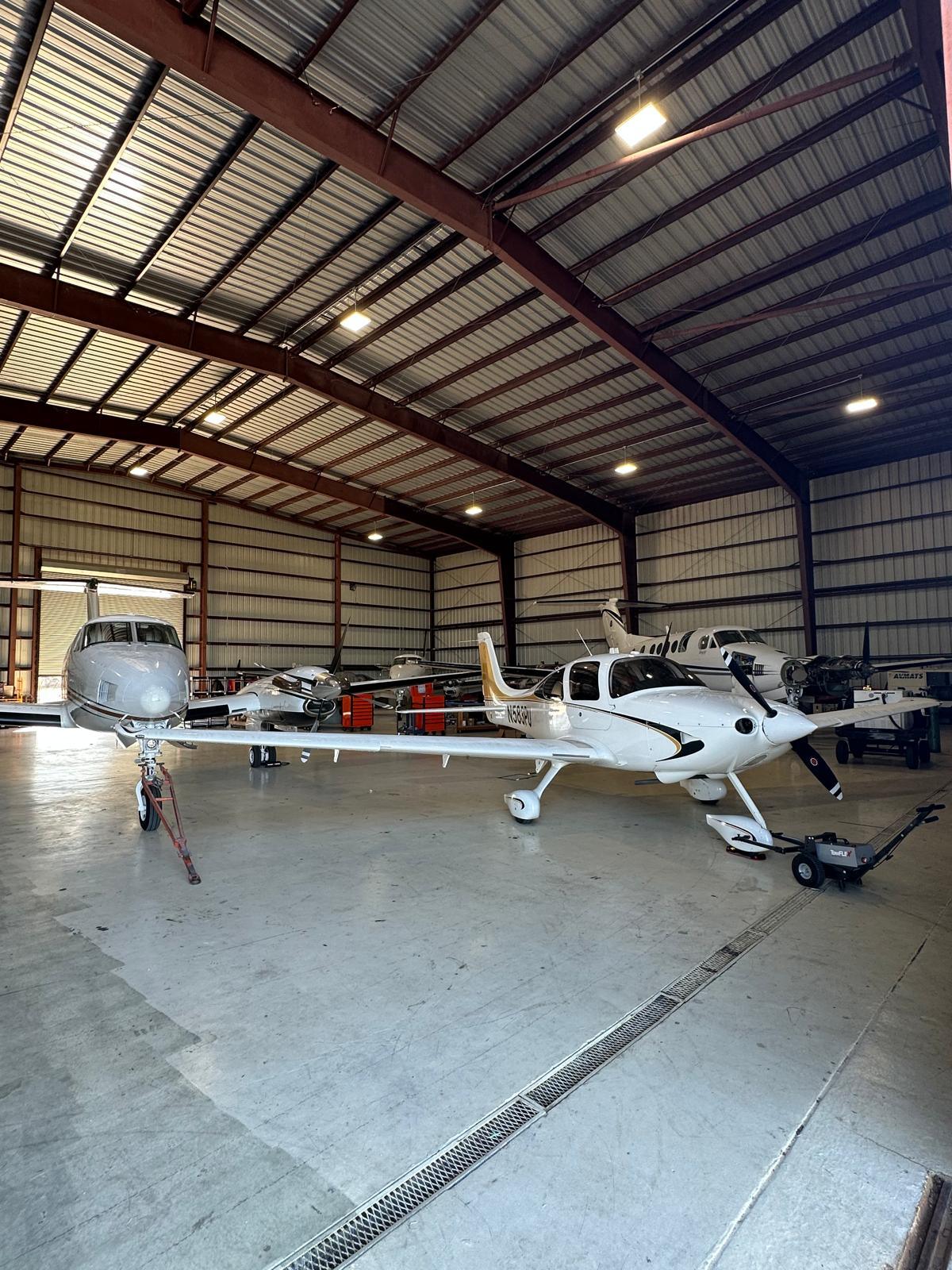 Cirrus single, Falcon jet and King Airs sharing the hangar floor.